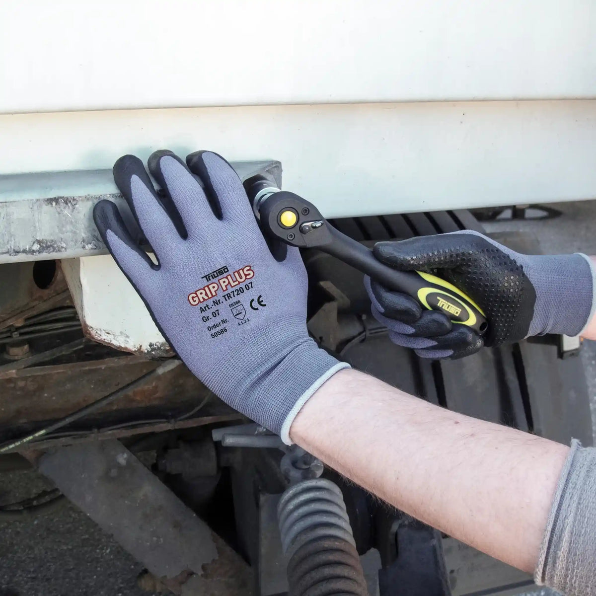 Example image of the Triuso Grip Plus gloves in use during a repair
